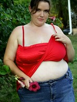 big girl posing outsite with flowers